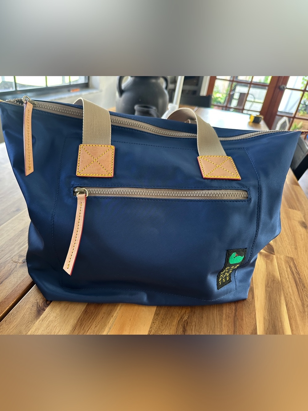 Dooney & Bourke Navy Duffel with Tan Accents